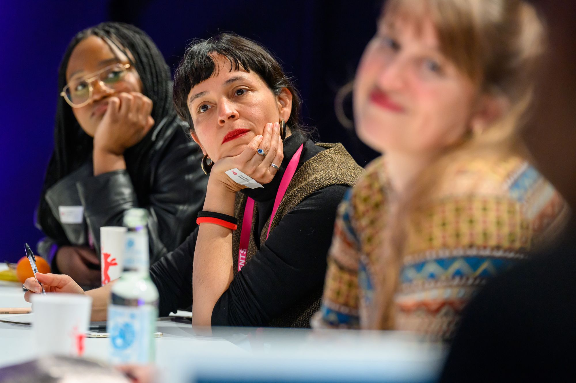 Kate Gondwe and Isabel Rojas listen attentively at the Market Studio Audience Design Workshop.